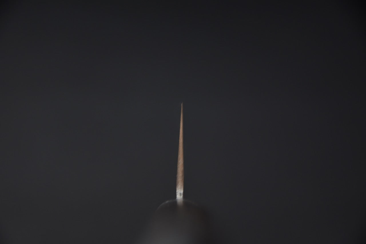 Vue du talon d'un couteau Nakiri japonais sur fond sombre