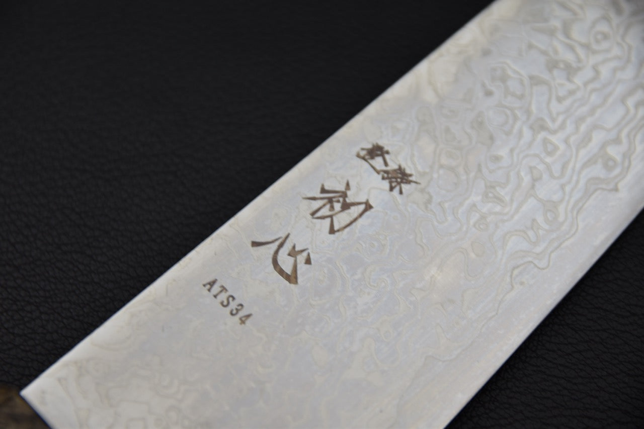 Profil de coupe du couteau japonais Santoku Hatsukokoro Ginga, finition damas ATS-34.
