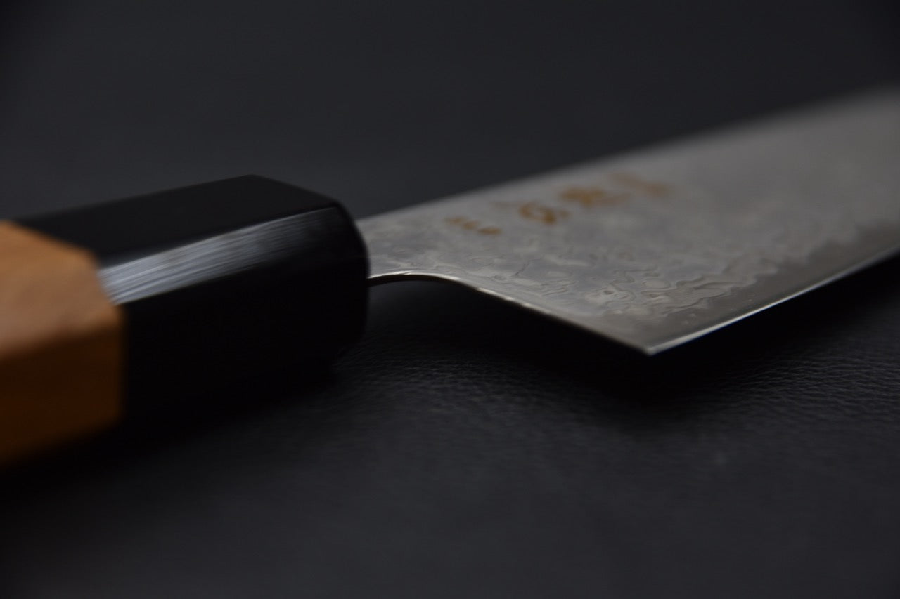 Vue du dos de la lame illustrant la finesse du tranchant du couteau japonais Santoku — Stay Sharp Montréal.