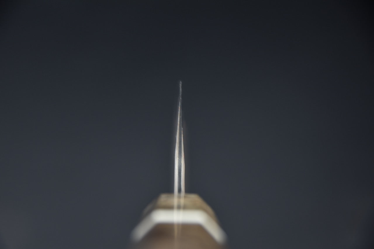 Vue du spine et de la pointe d’un couteau japonais bunka Rainbow Damascus 180mm.