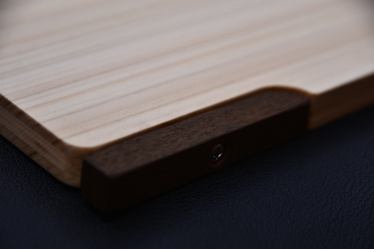 Vue rapprochée du pied rotatif en bois de rose fixé à la planche à découper japonaise Hitohira.