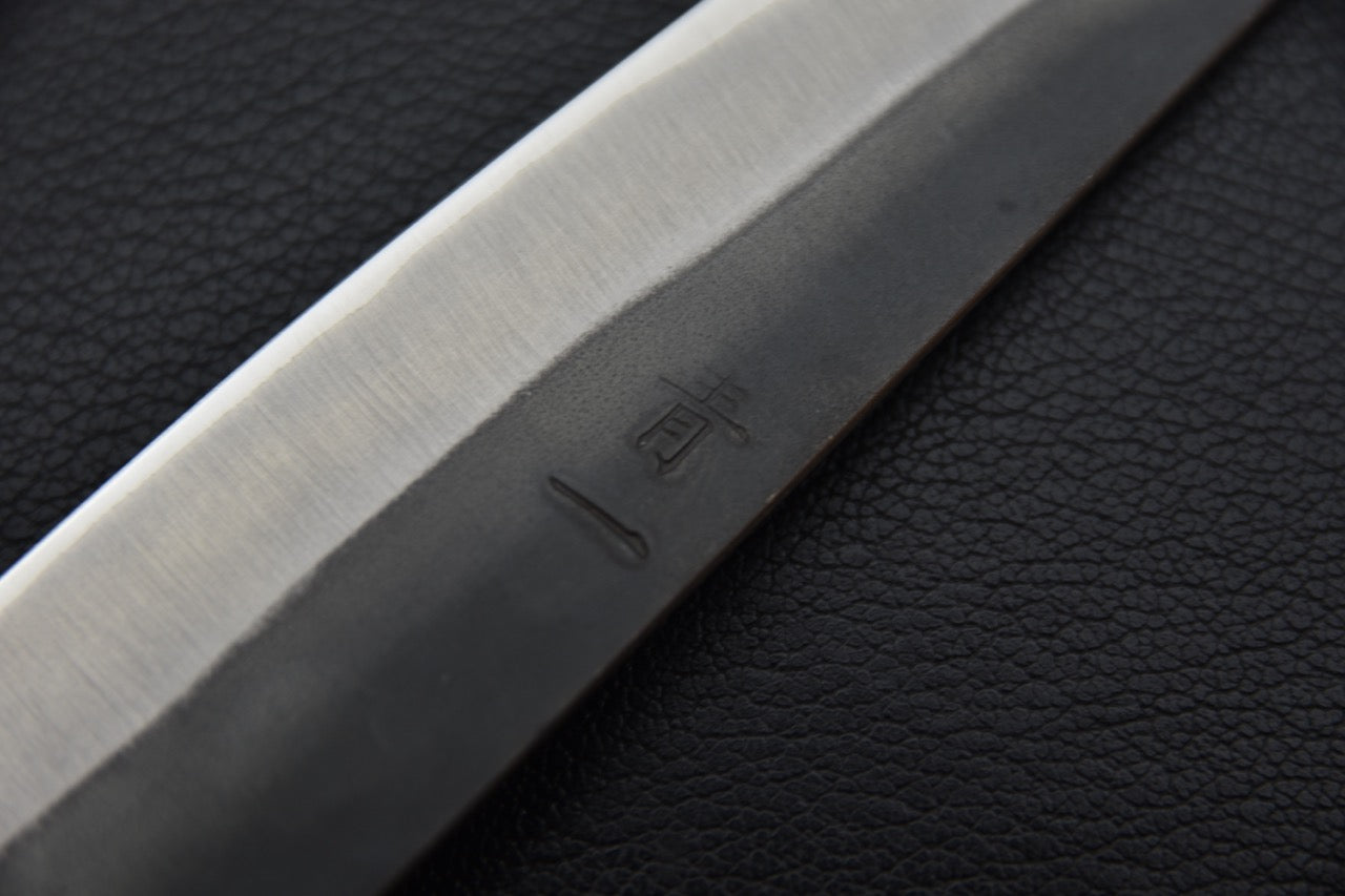 Gravure japonaise sur une lame en acier Aogami #1 d’un couteau japonais Petty.