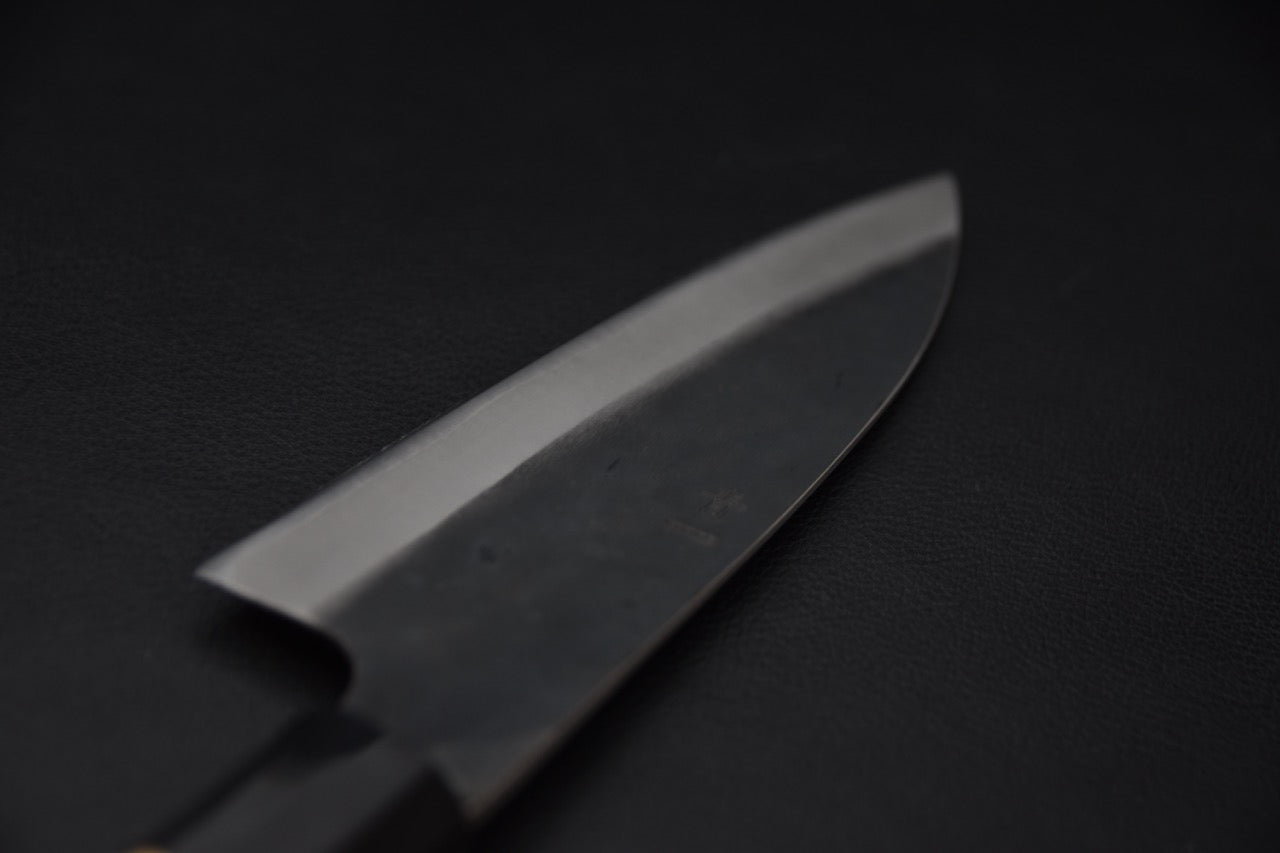 "Gros plan sur la gravure et la ligne de trempe du couteau japonais Hitohira Hizen Kurouchi Gyuto 155 mm."