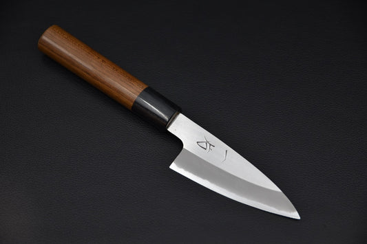 Japanese paring knife with a polished blade and a wooden handle featuring a dark ferrule, displayed on a black surface.
