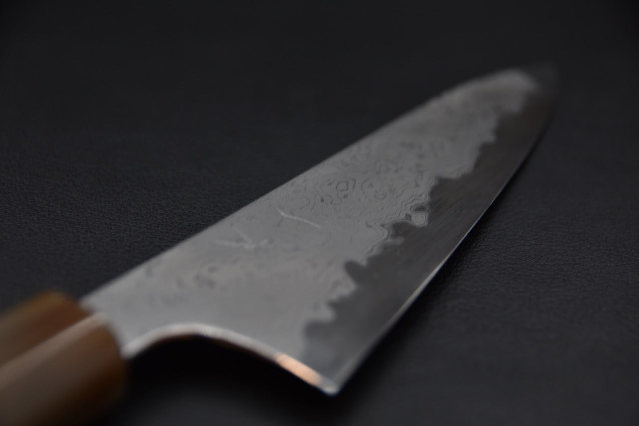 Zoom sur la lame avec ligne de trempe visible et reflets doux