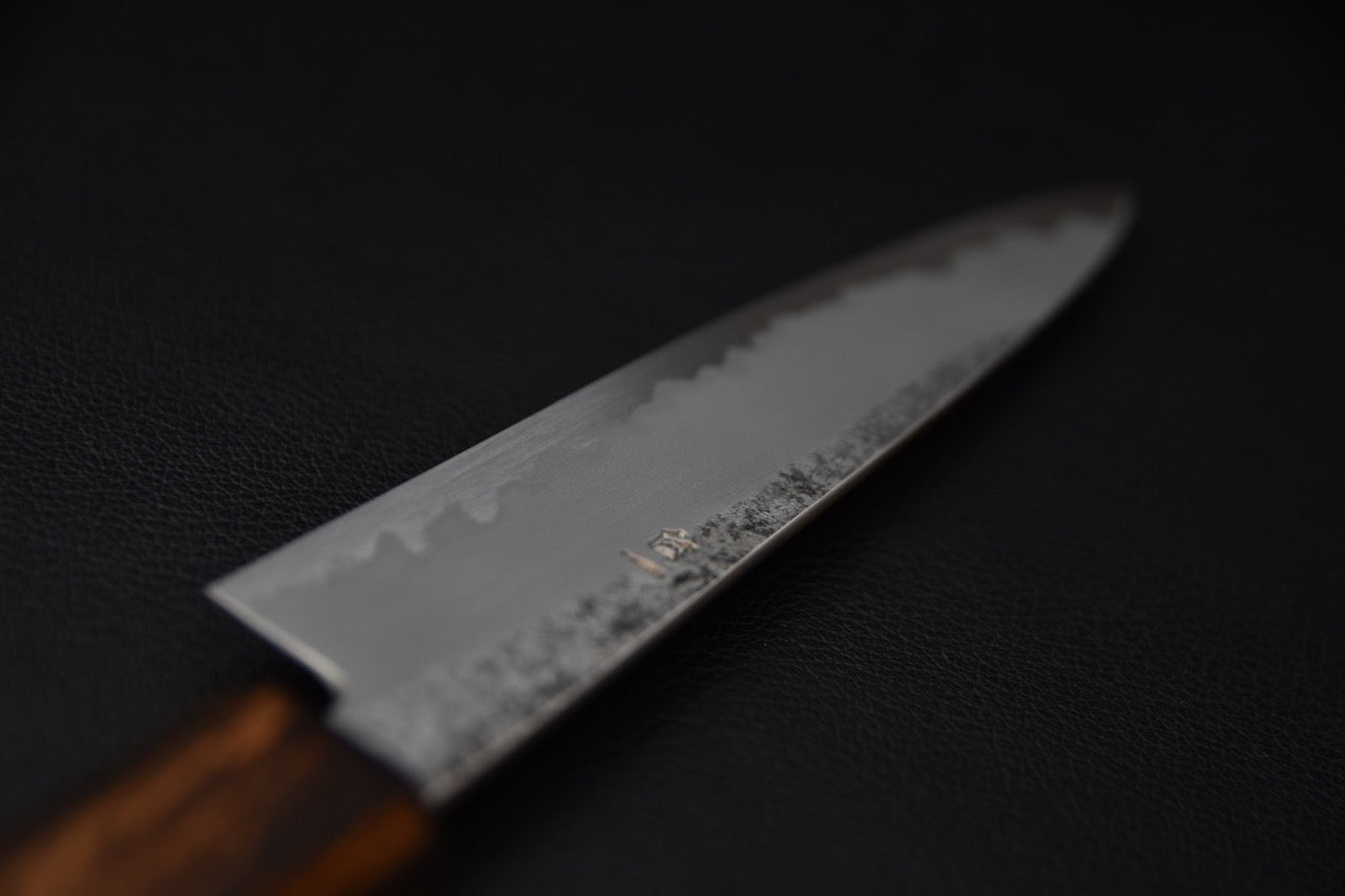 Profil du couteau japonais Petty montrant la ligne de trempe et la finesse du biseau.