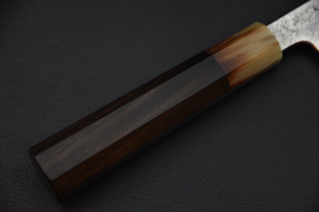 Manche en ébène d'un couteau japonais Gyuto sur surface noire