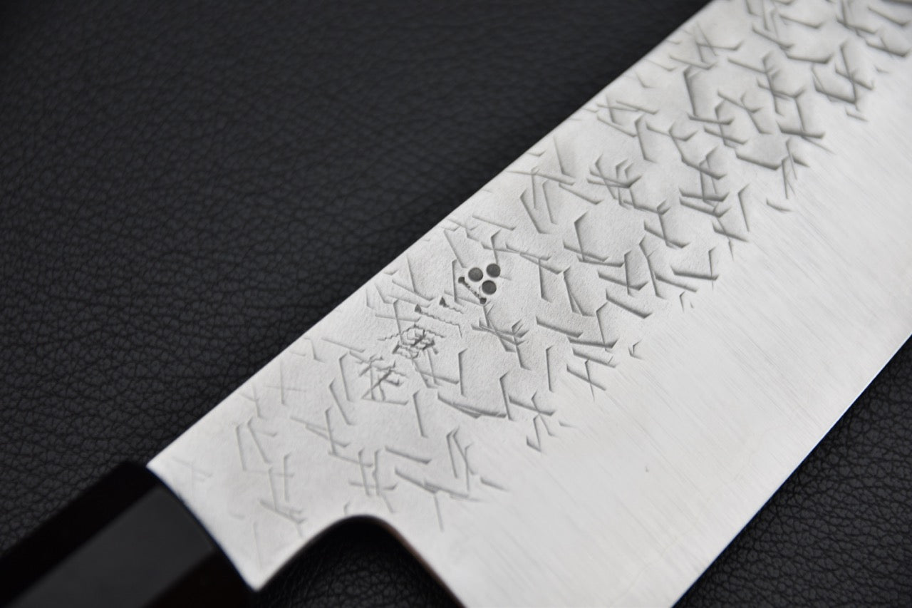 Nigara Hamono gyuto 210 mm — gros plan sur le motif gravé et les kanji près du talon