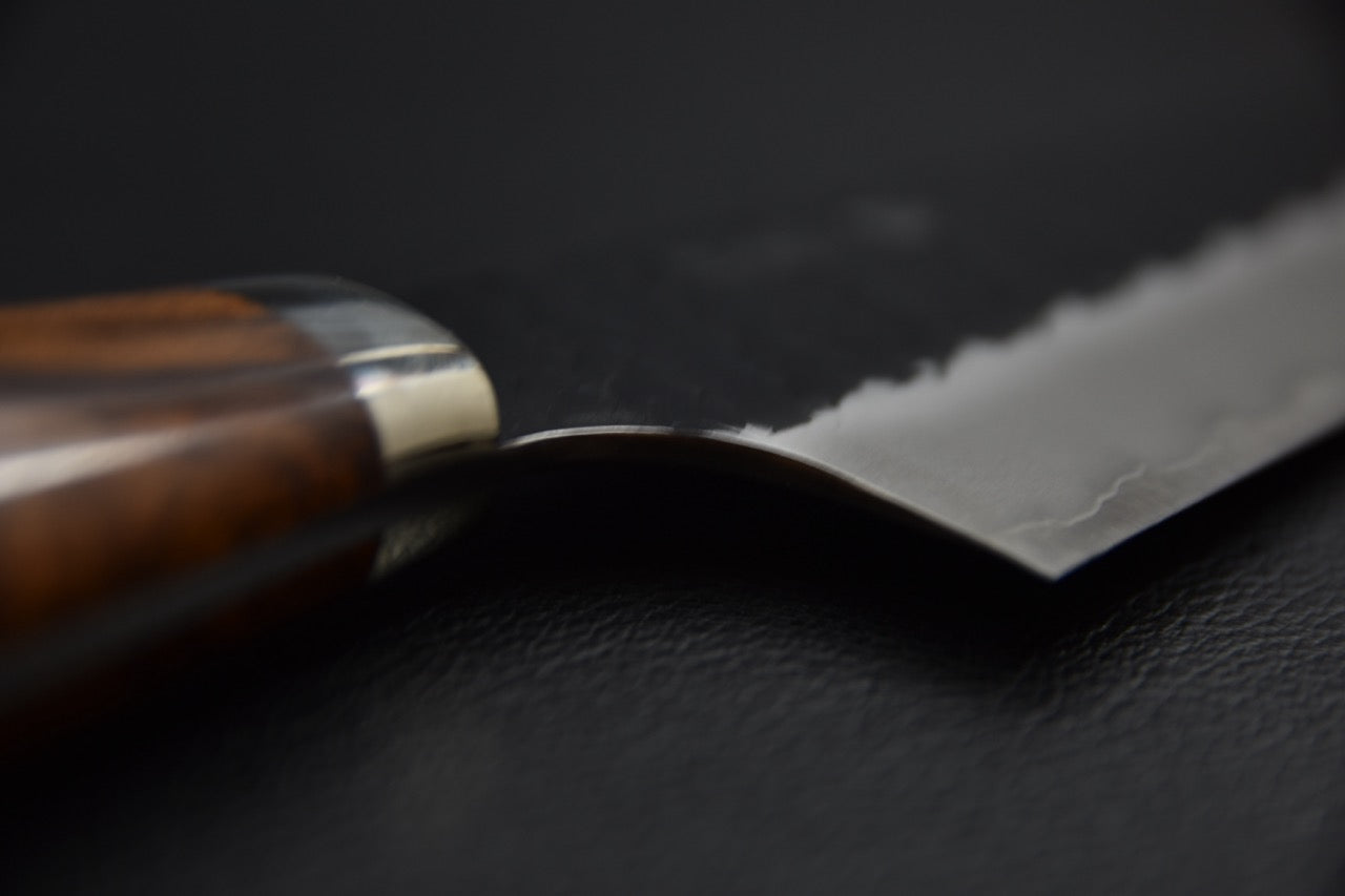 Couteau japonais gyuto 210 mm — gros plan sur la jonction manche et talon de lame, virole claire