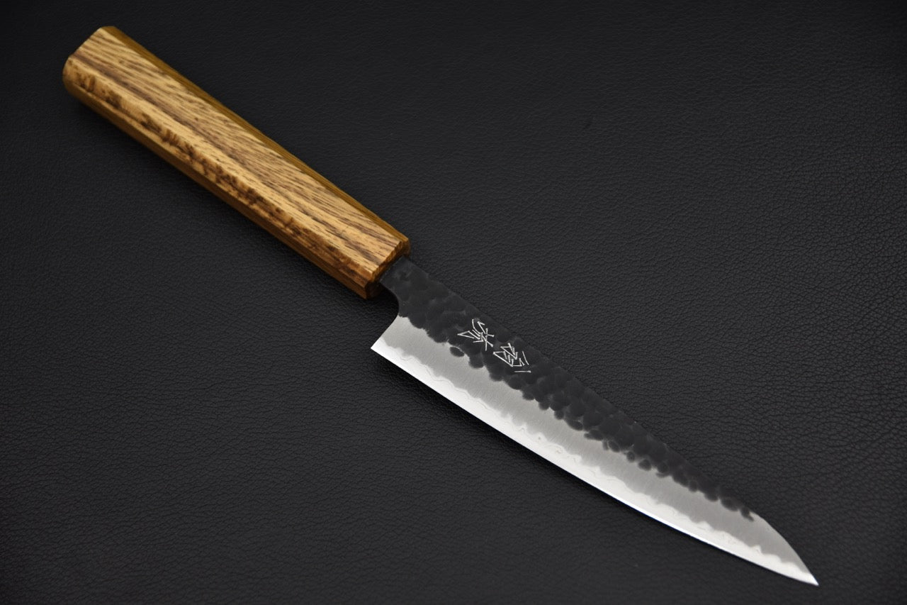 Couteau japonais petty 135 mm — vue complète de profil, manche wa en bois à grain prononcé, fond noir