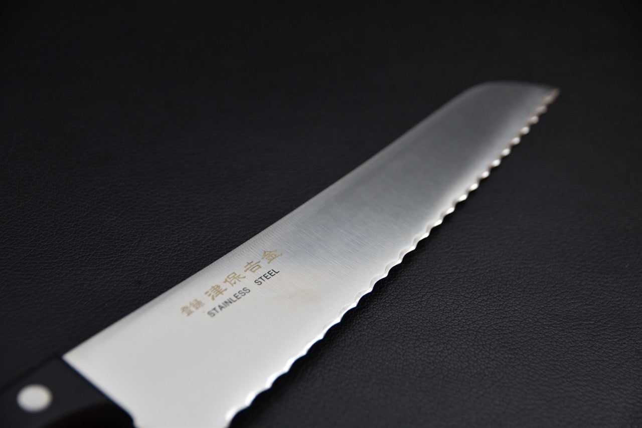 Couteau à pain 210 mm — gros plan sur la lame crantée et les kanji gravés
